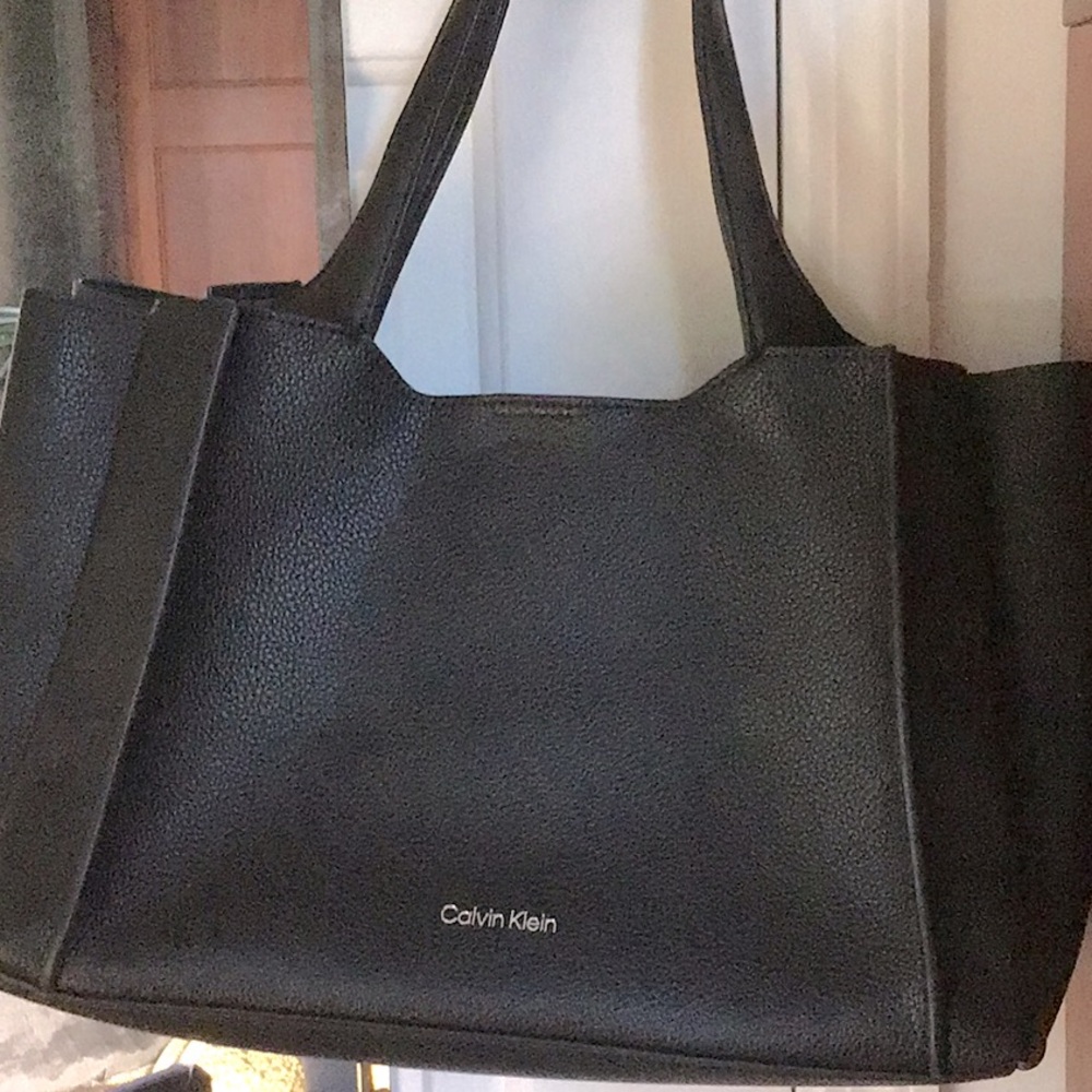 Like New no tags black Calvin Klein tote with   dust bag.14x7x9